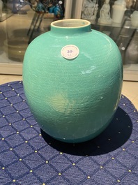 A Chinese verte biscuit figure, a green 'lotus' jar and a figurative blue and white plate, Kangxi and later
