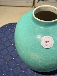 A Chinese verte biscuit figure, a green 'lotus' jar and a figurative blue and white plate, Kangxi and later