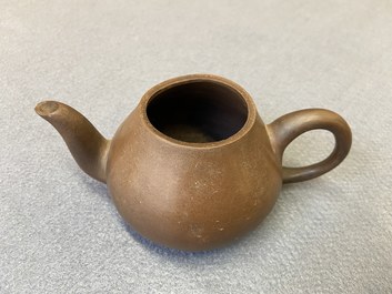 Four Chinese Yixing stoneware, blue and white and monochrome black porcelain teapots, Kangxi and later