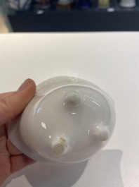A Chinese Dehua blanc de Chine tripod wine cup with inscription, Kangxi