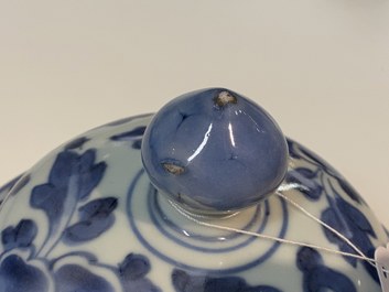 A pair of Chinese blue and white 'peony scroll' vases and covers, Kangxi