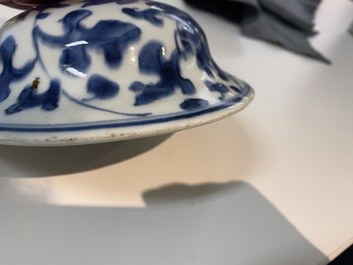 A pair of Chinese blue and white 'peony scroll' vases and covers, Kangxi