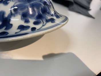 A pair of Chinese blue and white 'peony scroll' vases and covers, Kangxi