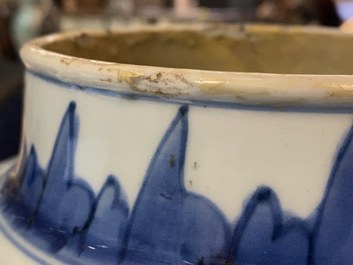 A pair of Chinese blue and white 'peony scroll' vases and covers, Kangxi