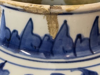 A pair of Chinese blue and white 'peony scroll' vases and covers, Kangxi
