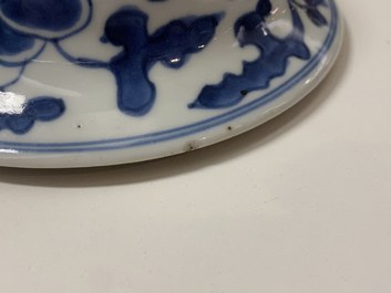 A pair of Chinese blue and white 'peony scroll' vases and covers, Kangxi