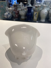 A Chinese Dehua blanc de Chine tripod wine cup with inscription, Kangxi