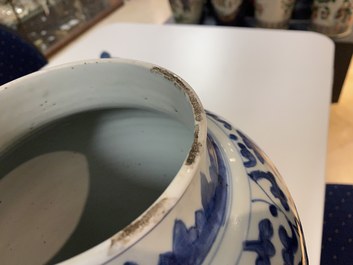 A pair of Chinese blue and white 'peony scroll' vases and covers, Kangxi