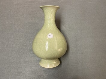 A Chinese monochrome celadon-glazed 'yuhuchunping' vase with underglaze floral design, Kangxi mark, 19th C.