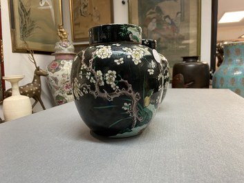 A pair of Chinese famille noire jars and covers, 19th C.