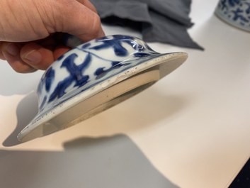A pair of Chinese blue and white 'peony scroll' vases and covers, Kangxi