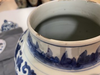 A pair of Chinese blue and white 'peony scroll' vases and covers, Kangxi