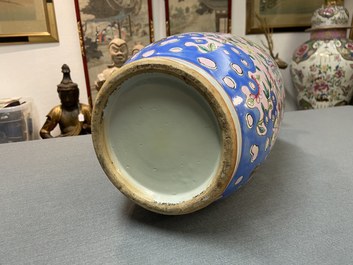 A Chinese pink-ground famille rose rouleau vase, 19th C.