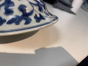 A pair of Chinese blue and white 'peony scroll' vases and covers, Kangxi