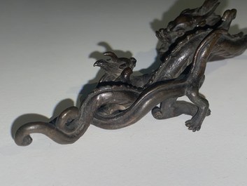 A rare Chinese bronze 'dragon' brush rest, Yuan/Ming