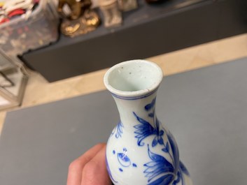 A Chinese blue and white double gourd vase with figures in a landscape, Transitional period