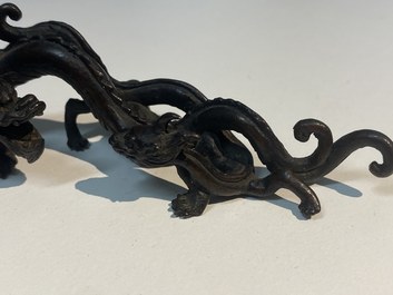 A rare Chinese bronze 'dragon' brush rest, Yuan/Ming
