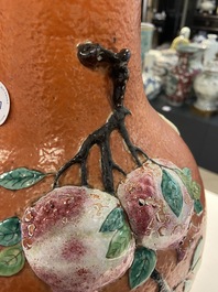 A Chinese famille rose 'sanduo' vase with applied design on a coral red ground, 19th C.