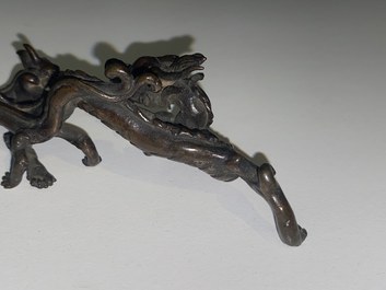 A rare Chinese bronze 'dragon' brush rest, Yuan/Ming