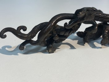 A rare Chinese bronze 'dragon' brush rest, Yuan/Ming