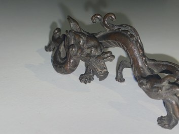A rare Chinese bronze 'dragon' brush rest, Yuan/Ming