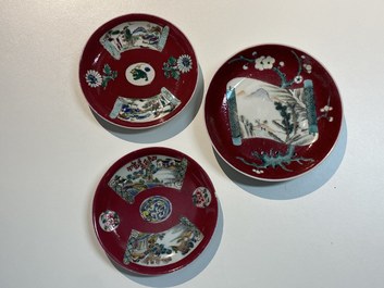 Three Chinese famille rose ruby-ground cups and saucers, Yongzheng