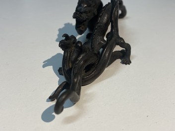 A rare Chinese bronze 'dragon' brush rest, Yuan/Ming