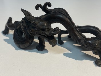 A rare Chinese bronze 'dragon' brush rest, Yuan/Ming