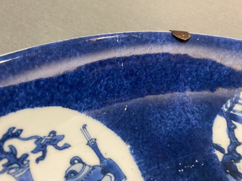 A Chinese blue, white and copper-red powder-blue-ground dish, Kangxi
