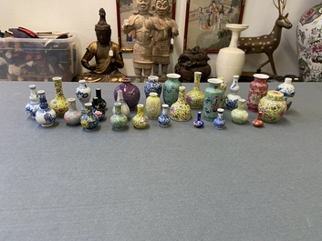 Twenty-eight Chinese blue and white and famille rose minature vases, Kangxi and later