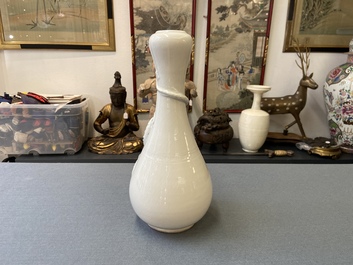A Chinese Dehua blanc de Chine vase with applied dragon, Kangxi/Yongzheng
