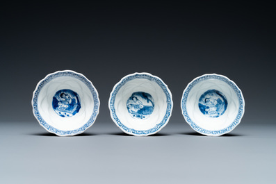 Three Chinese blue and white lotus-shaped 'acupuncture' cups and saucers, Kangxi