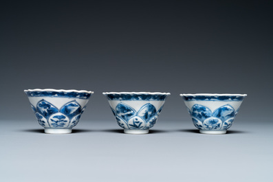 Three Chinese blue and white lotus-shaped 'acupuncture' cups and saucers, Kangxi