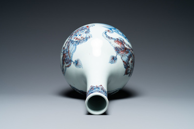 A Chinese blue, white and copper-red bottle vase with Buddhist lions, 20th C.
