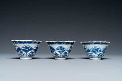 Three Chinese blue and white lotus-shaped 'acupuncture' cups and saucers, Kangxi