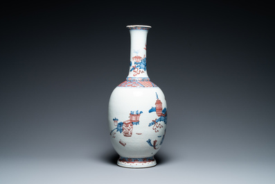 A Chinese blue, white and copper red 'antiquities' bottle vase, Qianlong
