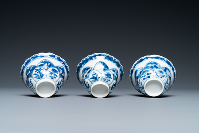 Three Chinese blue and white lotus-shaped 'acupuncture' cups and saucers, Kangxi