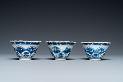 Three Chinese blue and white lotus-shaped 'acupuncture' cups and saucers, Kangxi
