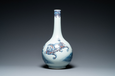A Chinese blue, white and copper-red bottle vase with Buddhist lions, 20th C.