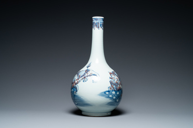 A Chinese blue, white and copper-red bottle vase with Buddhist lions, 20th C.