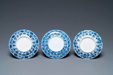 Three Chinese blue and white lotus-shaped 'acupuncture' cups and saucers, Kangxi
