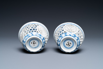 A pair of Chinese blue and white reticulated double-walled cups and saucers, Kangxi