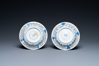 A pair of Chinese blue and white reticulated double-walled cups and saucers, Kangxi