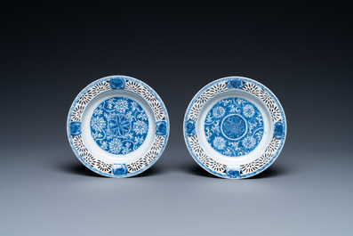 A pair of Chinese blue and white reticulated double-walled cups and saucers, Kangxi