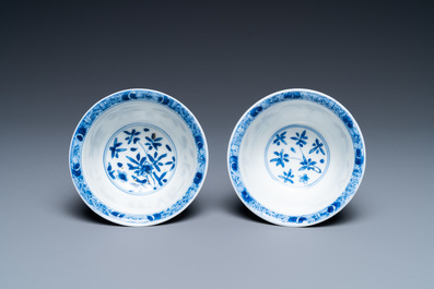 A pair of Chinese blue and white reticulated double-walled cups and saucers, Kangxi