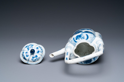 A Chinese blue and white arch-handled teapot and cover, Kangxi