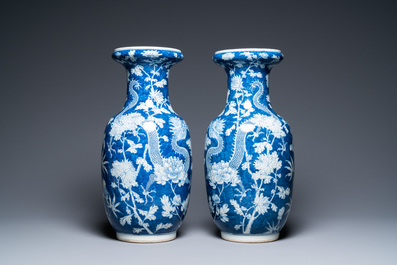 A pair of Chinese blue and white 'dragon and peony' vases, 19th C.