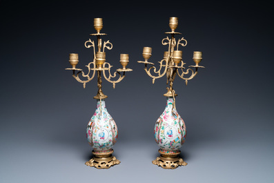 A pair of Chinese gilt brass candelabra-mounted Canton famille rose vases, 19th C.