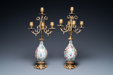 A pair of Chinese gilt brass candelabra-mounted Canton famille rose vases, 19th C.