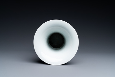A Chinese blue, white and copper-red 'gu' vase with lotus scrolls, Kangxi